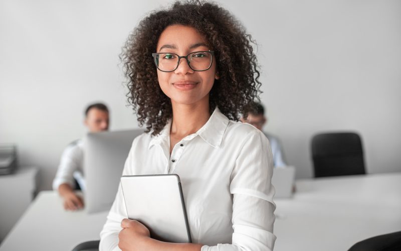 smiling-ethnic-female-recruiter-with-tablet-looking-at-camera-in-office.jpg